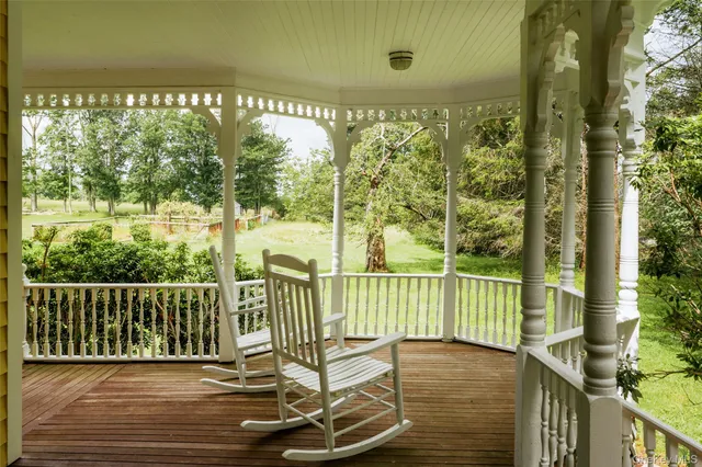 a view of a balcony with floor to ceiling window wooden floor and outdoor space
