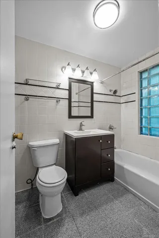 a bathroom with a sink a toilet and bathtub