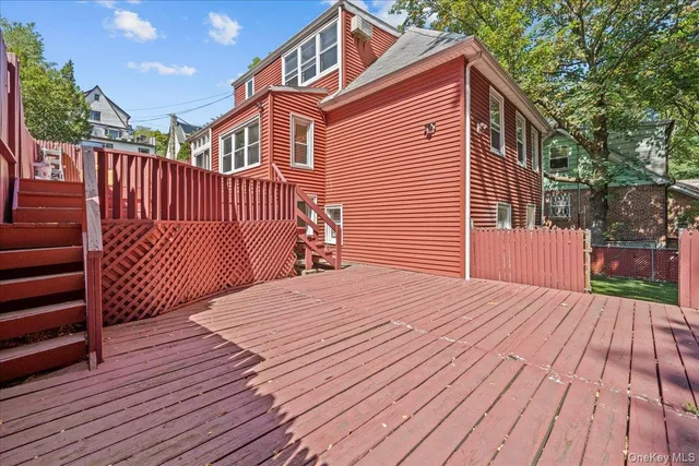 a view of a house with wooden deck