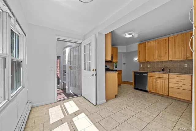 a kitchen with a refrigerator and white cabinets