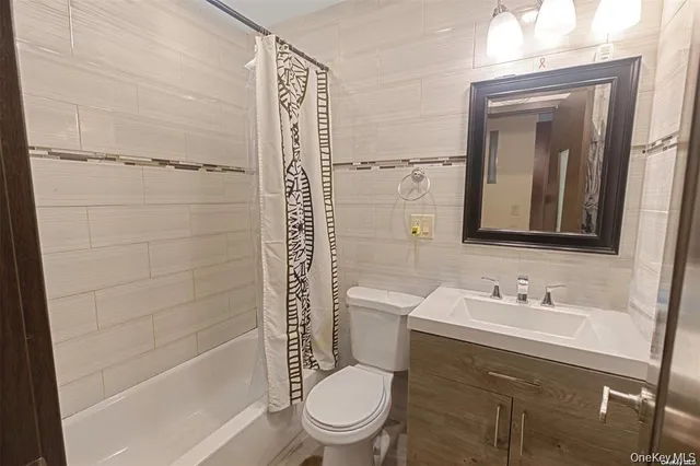 a bathroom with a toilet a sink and shower