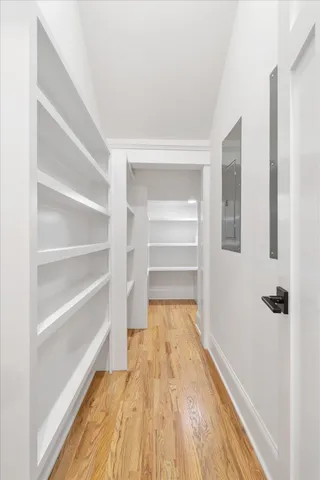 a view of walk in closet with empty racks