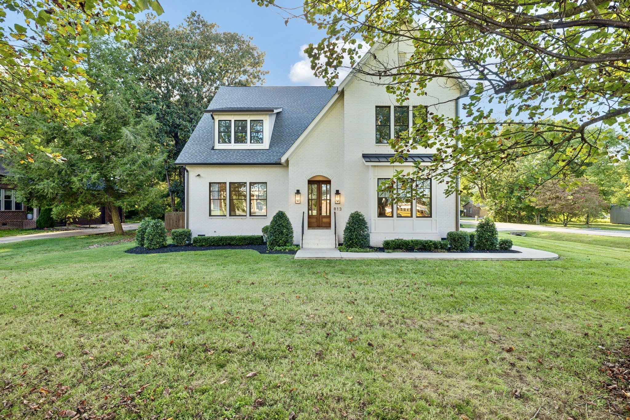 813 Hillsboro Road Franklin, TN 37064 - Photo 3 of 79 a front view of a house with a yard and trees