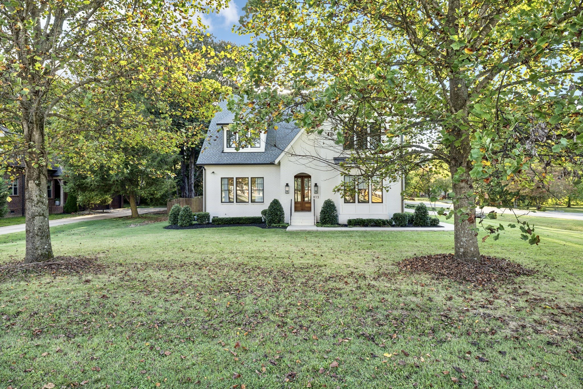 813 Hillsboro Road Franklin, TN 37064 - Photo 4 of 79 a front view of a house with a yard and trees