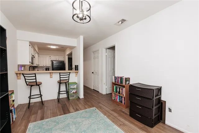 a view of a dining room with furniture and wooden floor