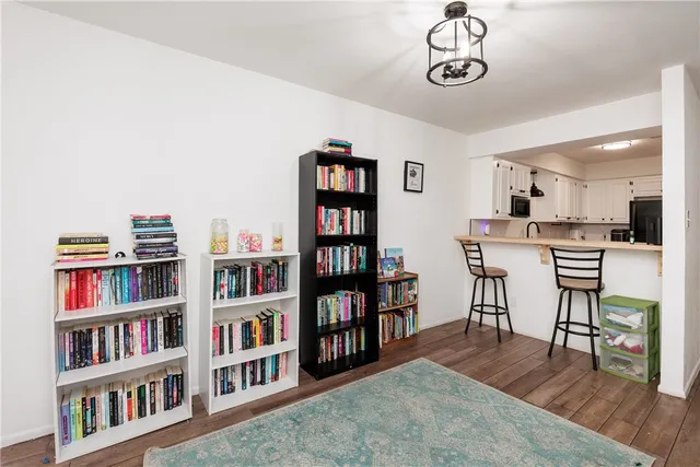 a view of a livingroom with furniture and a bookshelf