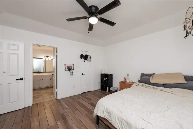 a bedroom with a bed and wooden floor