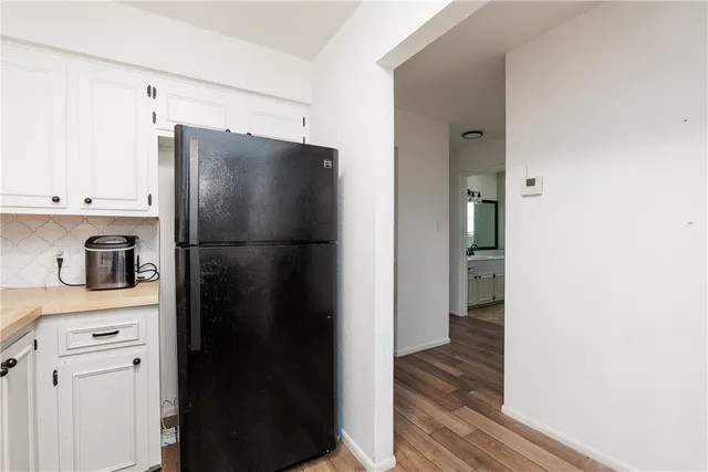 a kitchen with stainless steel appliances a refrigerator and cabinets