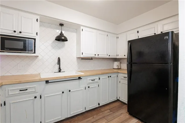 a kitchen with a sink and a refrigerator
