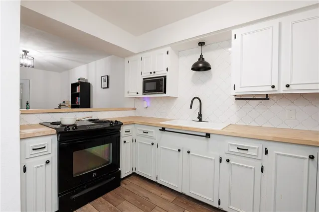 a kitchen with cabinets appliances and a sink