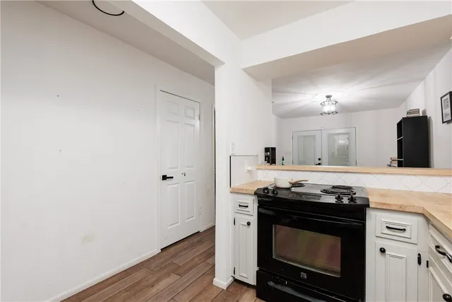 a kitchen with granite countertop a stove and a sink