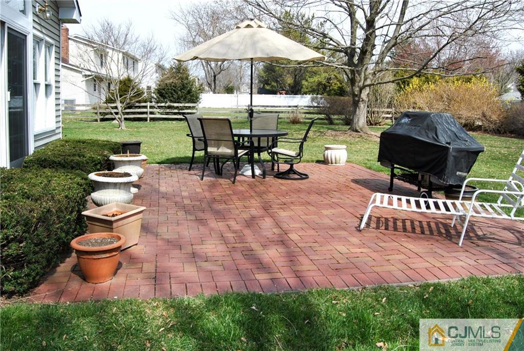 18 Krebs Road Plainsboro, NJ 08536 - Photo 20 of 24 a view of a patio with table and chairs potted plants and a garden