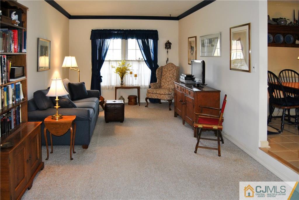 18 Krebs Road Plainsboro, NJ 08536 - Photo 7 of 24 a living room with furniture a bookshelf and a window