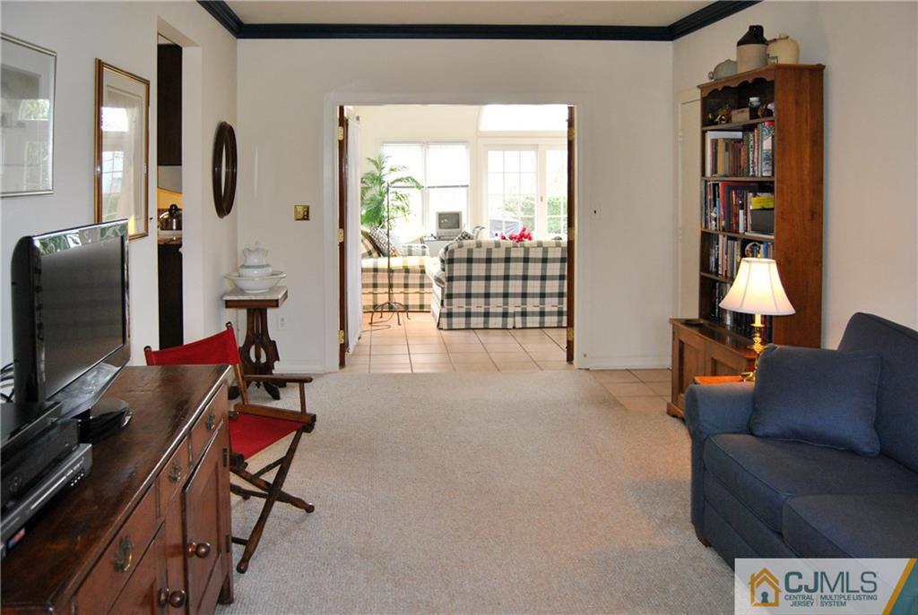 18 Krebs Road Plainsboro, NJ 08536 - Photo 8 of 24 a living room with furniture a flat screen tv and a window