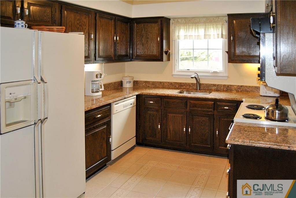 18 Krebs Road Plainsboro, NJ 08536 - Photo 9 of 24 a kitchen with a sink a stove and refrigerator