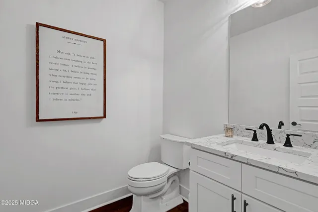 a living room with furniture and a kitchen view