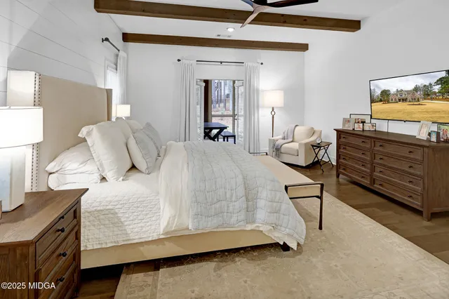 a kitchen with stainless steel appliances kitchen island granite countertop a table chairs stove and white cabinets