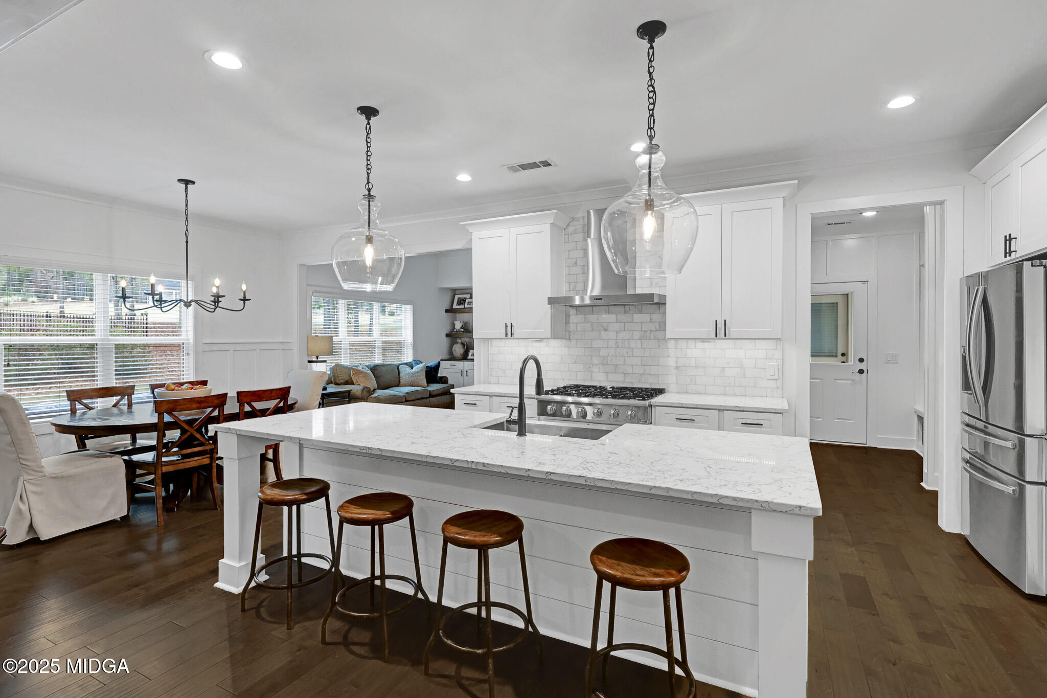 205 Chastain Drive Forsyth, GA 31029 - Photo 29 of 72 a large kitchen with granite countertop a stove a sink a center island a table and chairs