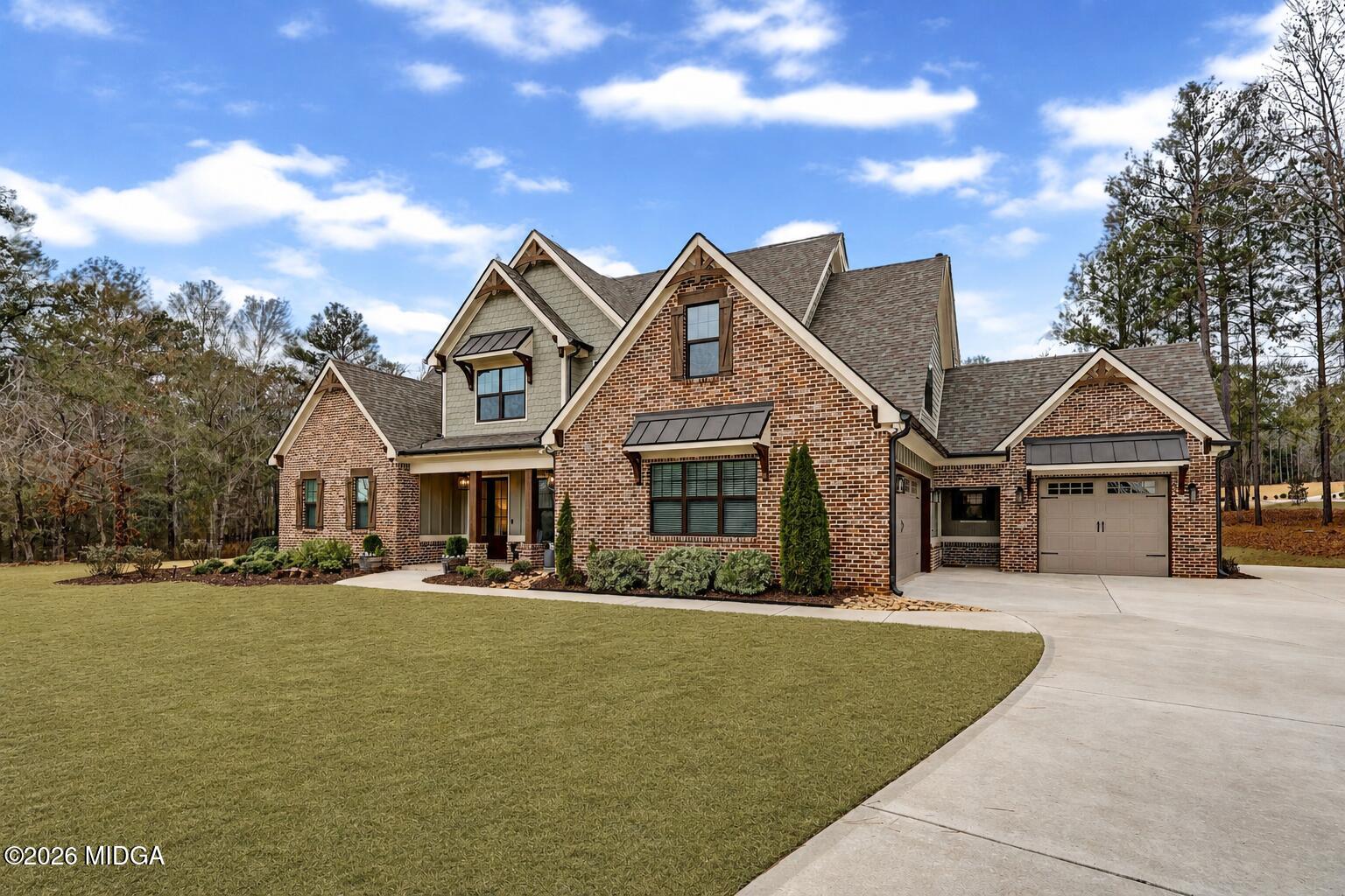205 Chastain Drive Forsyth, GA 31029 - Photo 3 of 72 a front view of house with yard and trees around