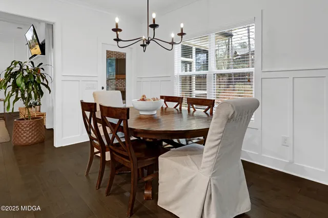 an aerial view of a house with a yard and large trees