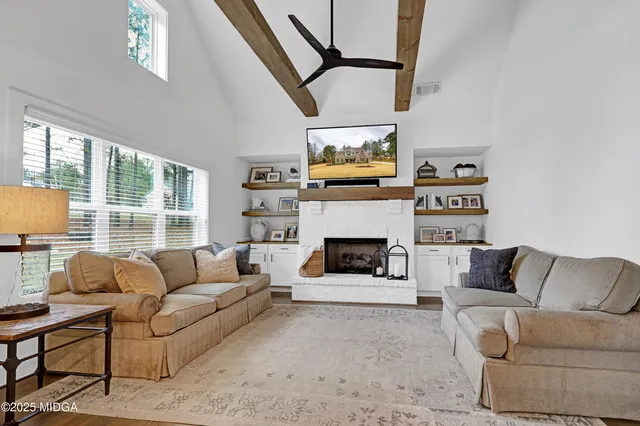 a view of a small house with wooden fence