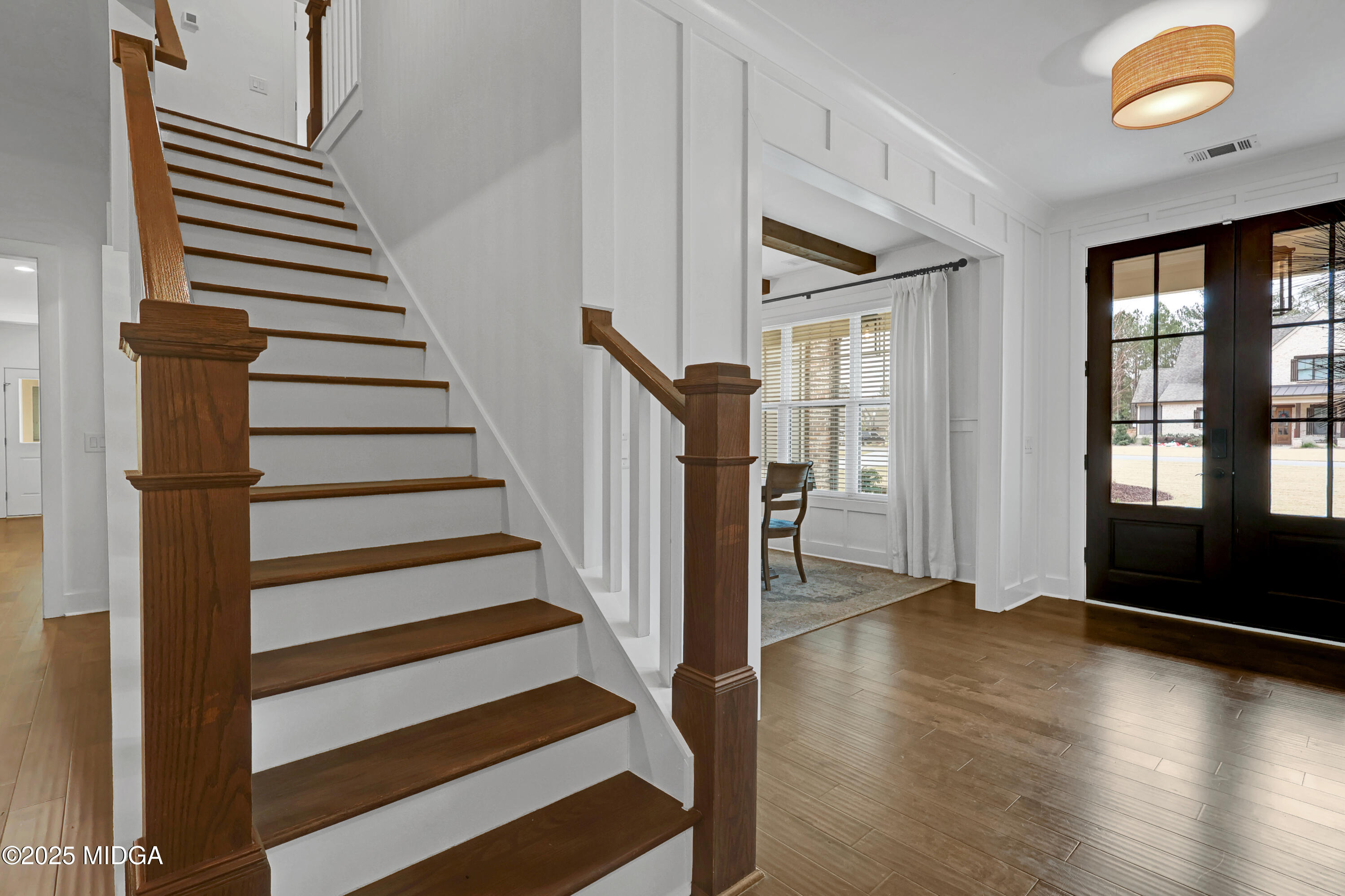 205 Chastain Drive Forsyth, GA 31029 - Photo 40 of 72 a view of a hallway to a livingroom with wooden floor and windows