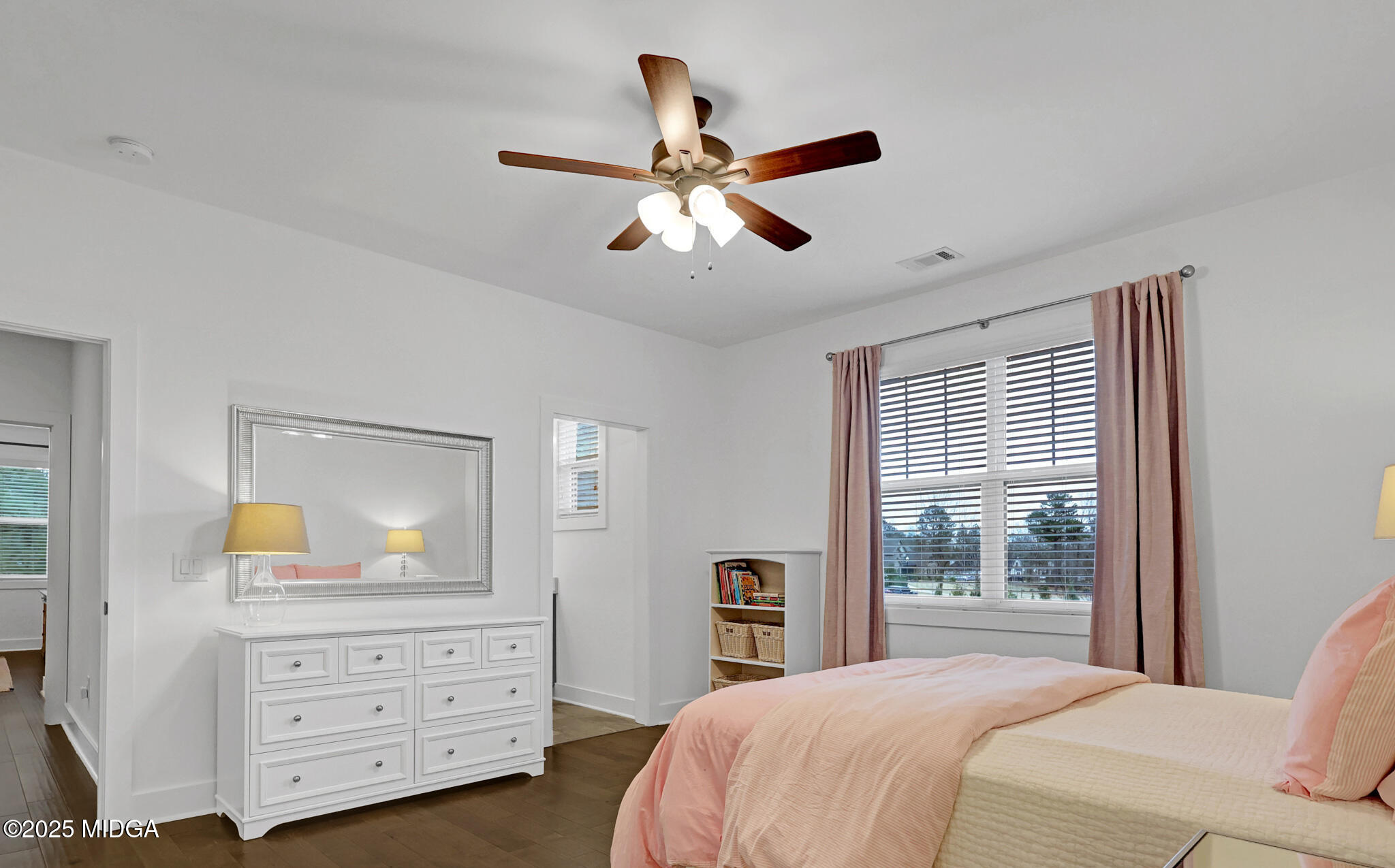 205 Chastain Drive Forsyth, GA 31029 - Photo 43 of 72 a bedroom with a bed a chandelier and a mirror on the dresser