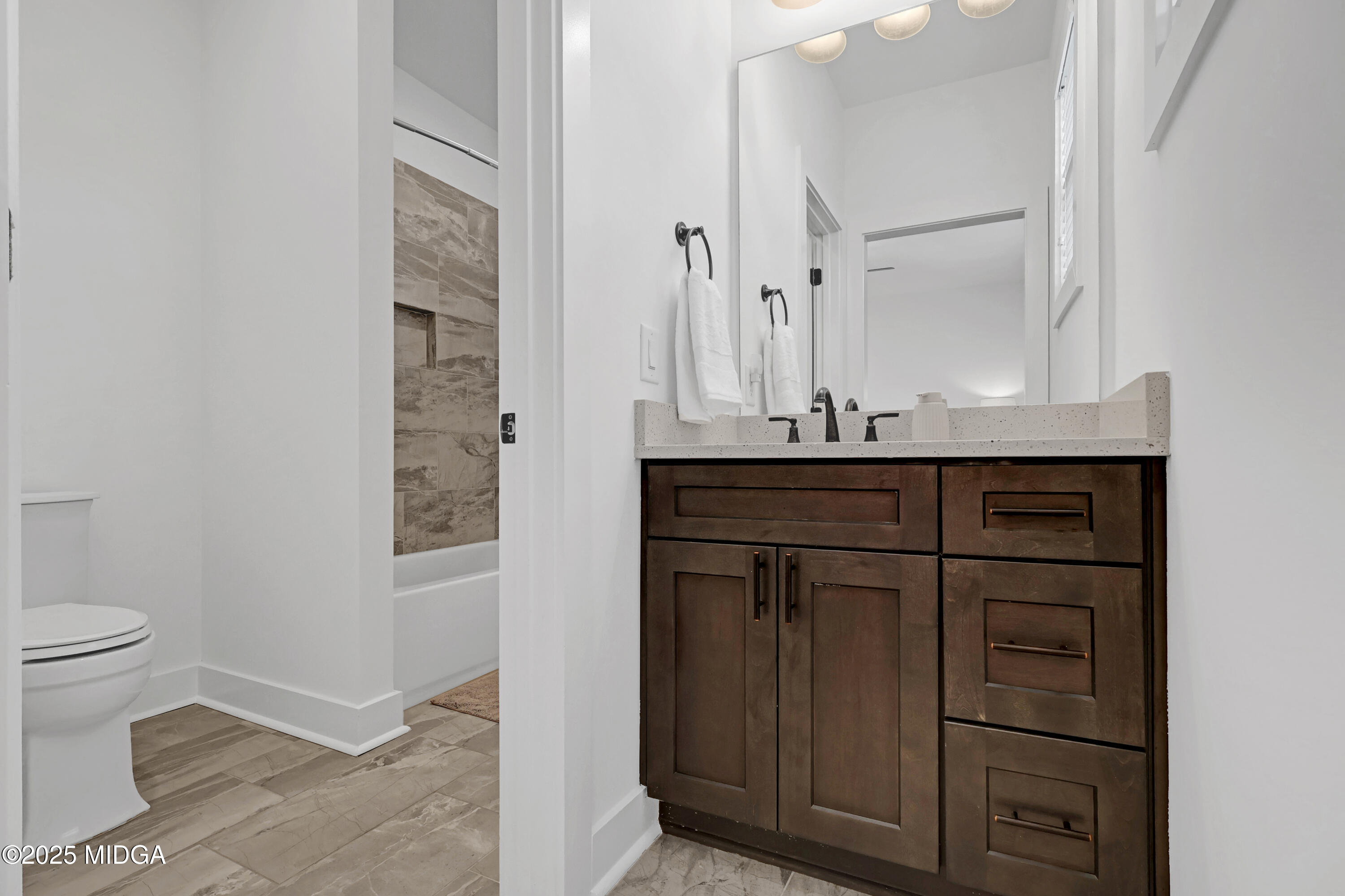 205 Chastain Drive Forsyth, GA 31029 - Photo 47 of 72 a bathroom with a sink a toilet and a mirror