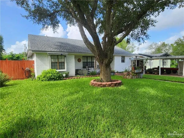 a view of a house with backyard sitting area and garden