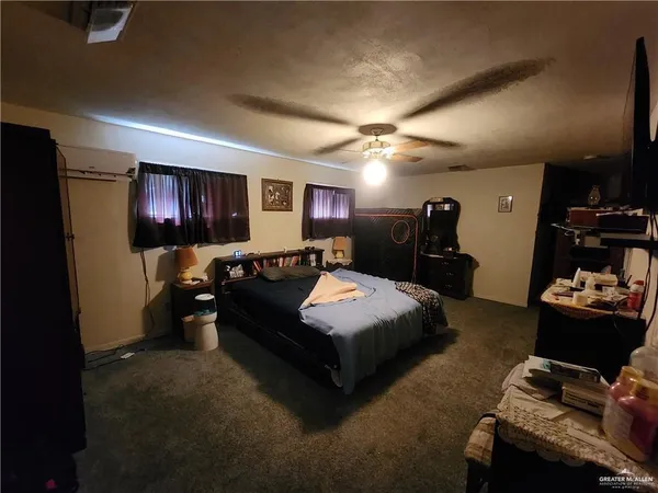 a spacious bedroom with a bed and a large mirror