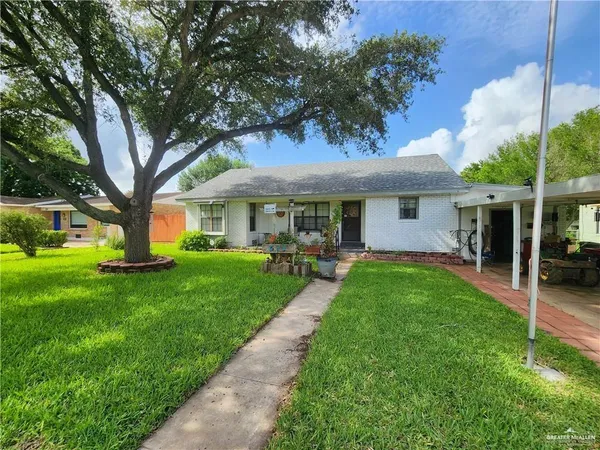 a front view of a house with a yard table and chairs