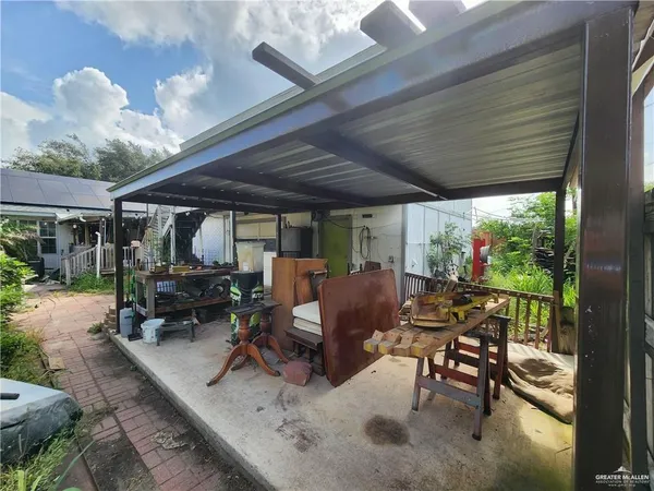 a view of a patio with table and chairs and potted plants