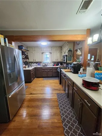 a large kitchen with lots of counter top space and stainless steel appliances