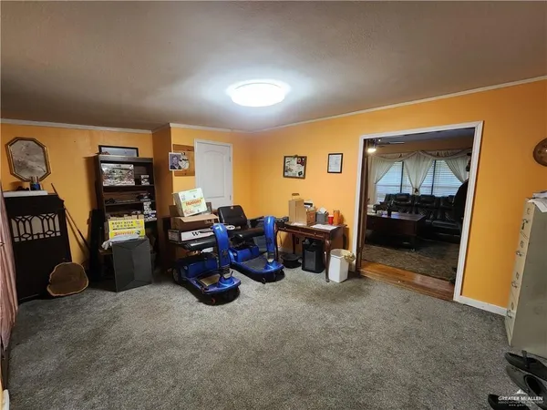 a living room with furniture a window and gym equipment