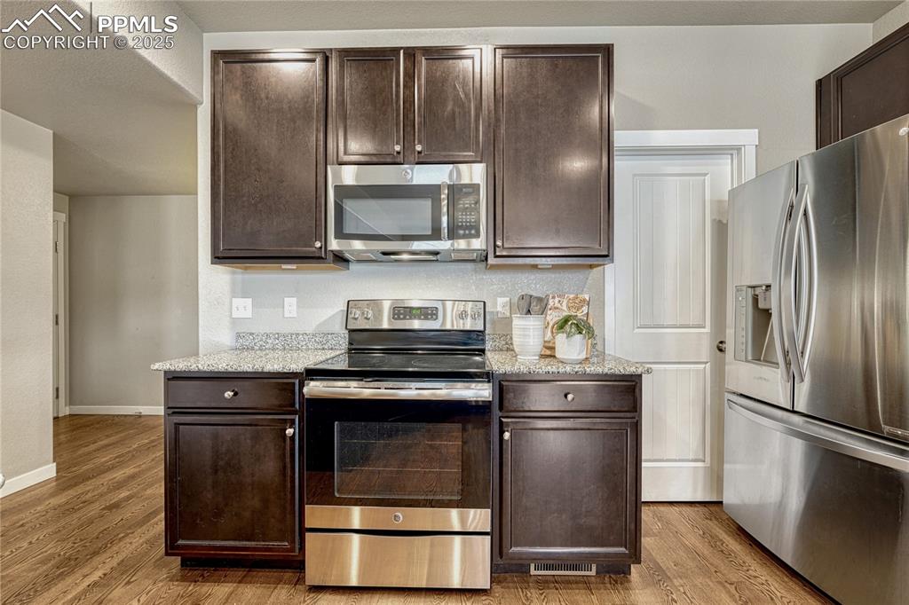 11298 Scenic Brush Drive Peyton, CO 80831 - Photo 13 of 50 a kitchen with a stove microwave and refrigerator