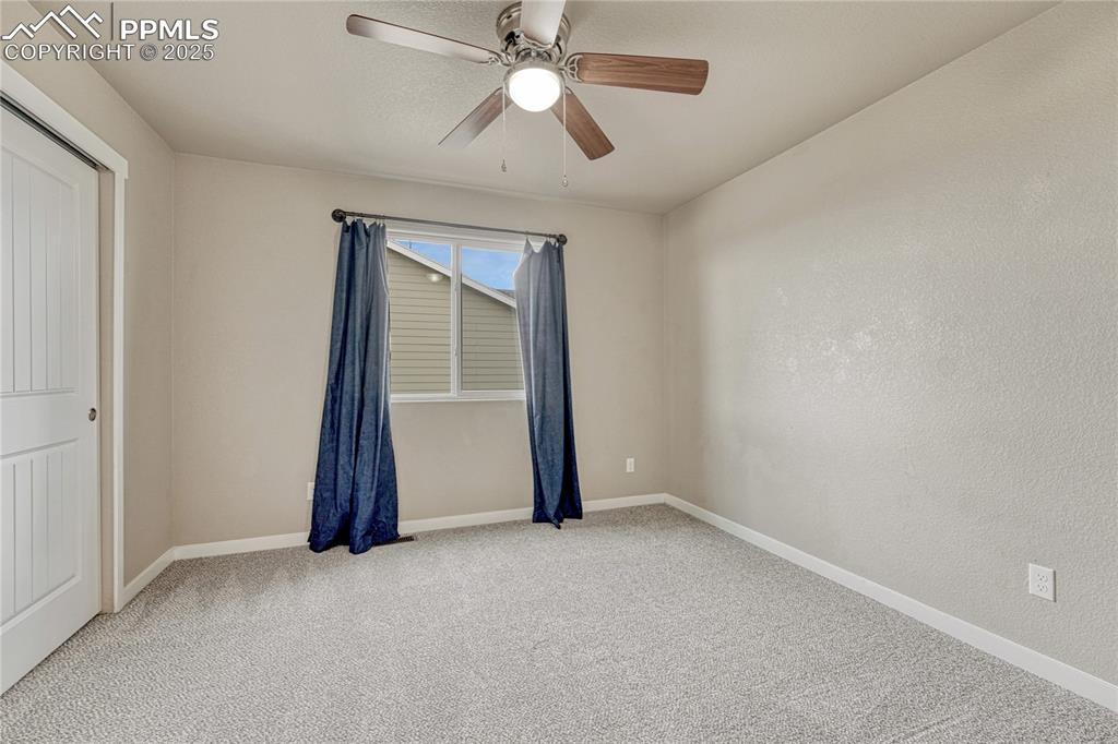 11298 Scenic Brush Drive Peyton, CO 80831 - Photo 33 of 50 an empty room with closet and a chandelier fan