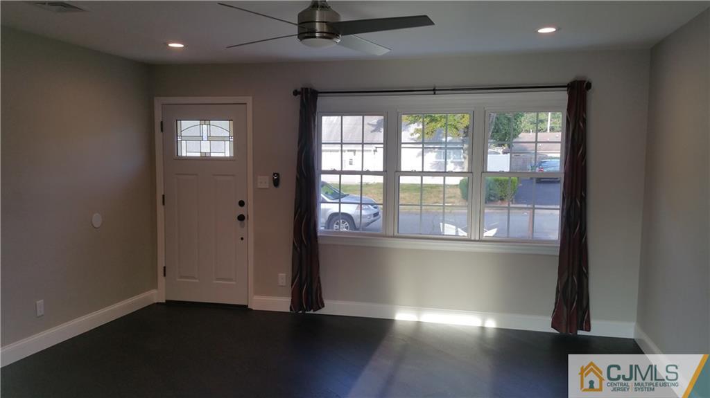 10 Richmond Road Edison, NJ 08817 - Photo 4 of 12 a view of empty room with wooden floor and fan