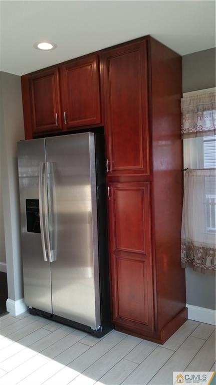 10 Richmond Road Edison, NJ 08817 - Photo 7 of 12 a metallic refrigerator freezer sitting in a kitchen