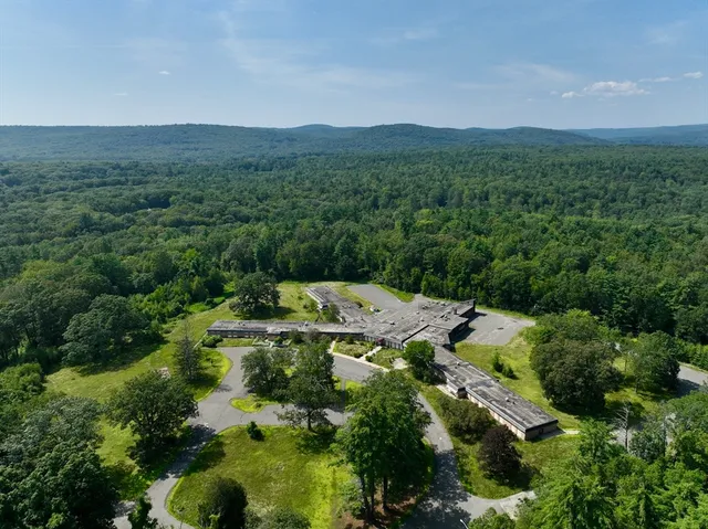 an aerial view of a house with yard and outdoor seating