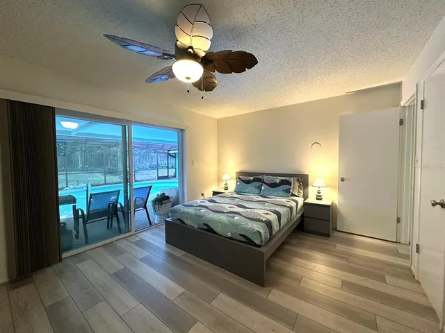 a spacious bedroom with a bed and a chandelier