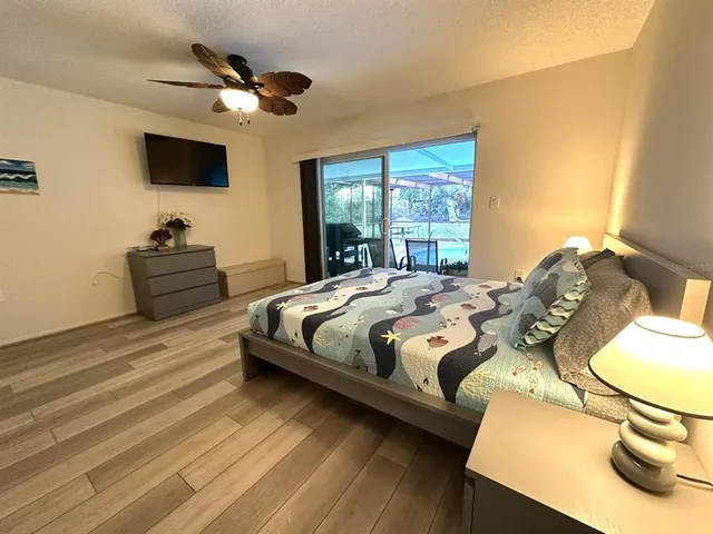 a bedroom with a bed and a flat screen tv