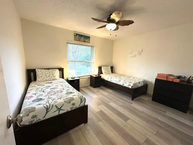 a bedroom with double bed and a chandelier