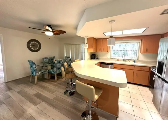 a kitchen with a table chairs a sink and a stove