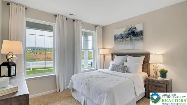 a bedroom with a large bed and a window