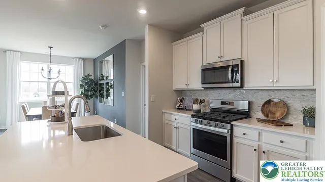 a kitchen with appliances a sink and cabinets