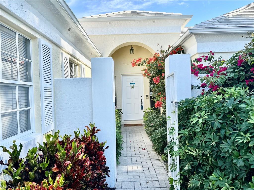 7010 Rue De Marquis Naples, FL 34108 - Photo 4 of 8 Entrance to property with stucco siding