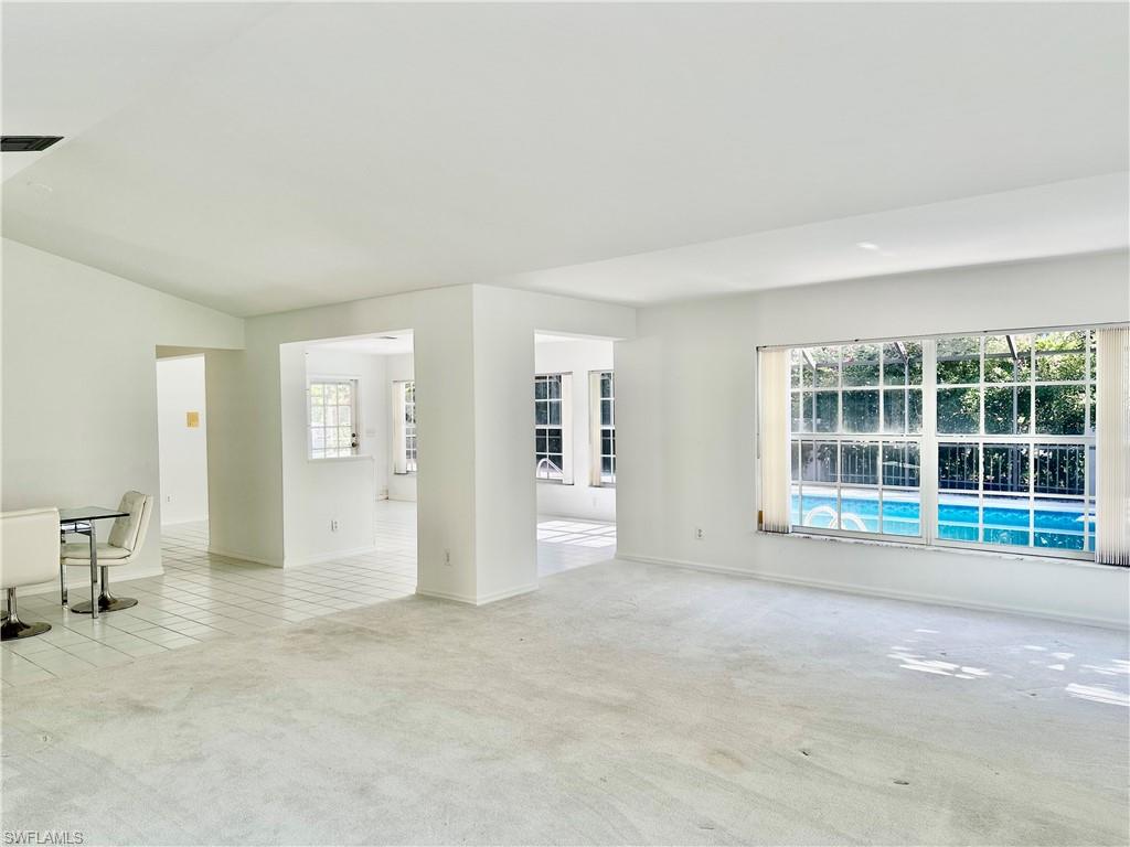 7010 Rue De Marquis Naples, FL 34108 - Photo 5 of 8 Unfurnished room with light colored carpet and plenty of natural light