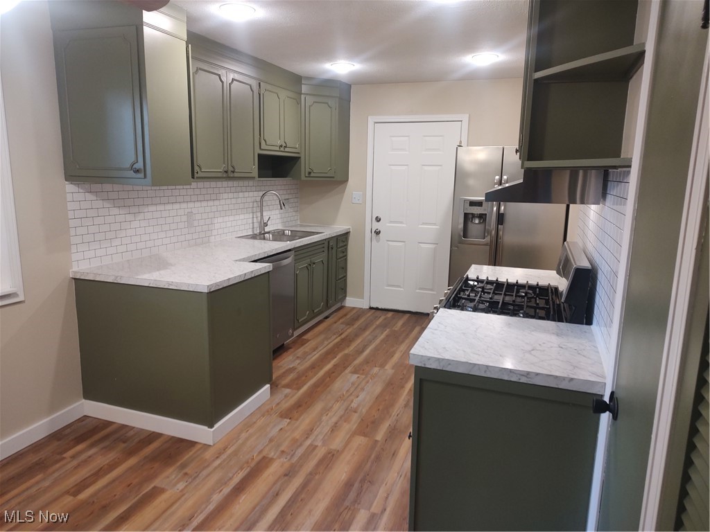 1750 Trinity Road Madison, OH 44057 - Photo 11 of 28 Kitchen featuring a sink, open shelves, dishwasher, and stove
