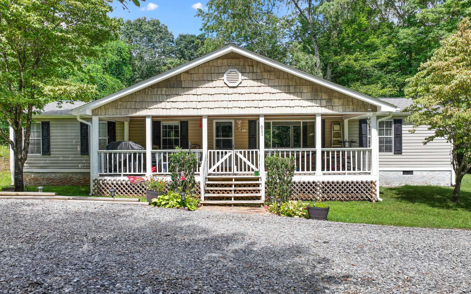 611 Wash Wilson Road Blue Ridge, GA 30513 - Photo 25 of 26 a front view of a house with a garden and yard