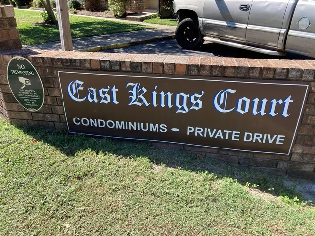 a view of outdoor space with signage and flags
